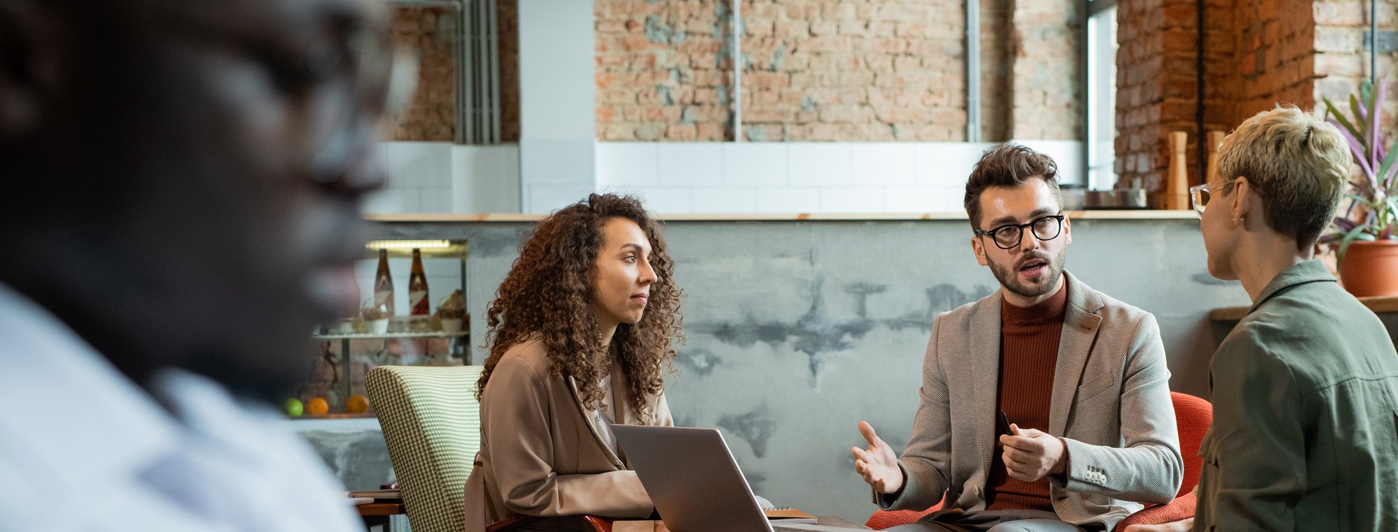 three-managers-discussing-their-ideas-by-table-2021-09-24-03-45-39-utc-(1)